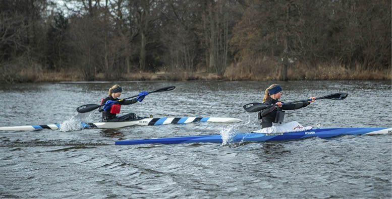 A close-up of a blue, white, and black striped pole floating on rippling water. Description generated by AI
